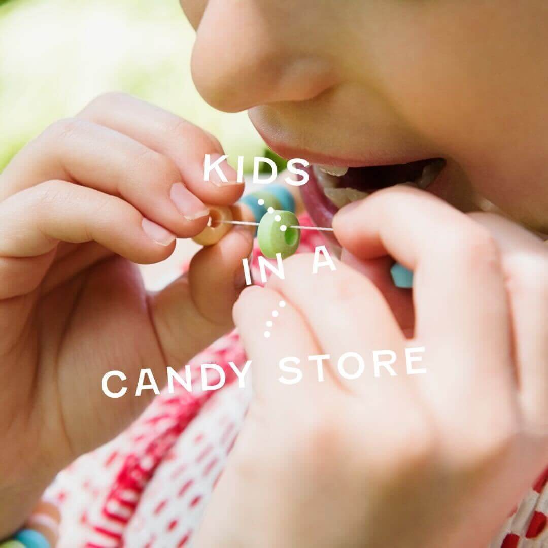 kind eating a candy necklace