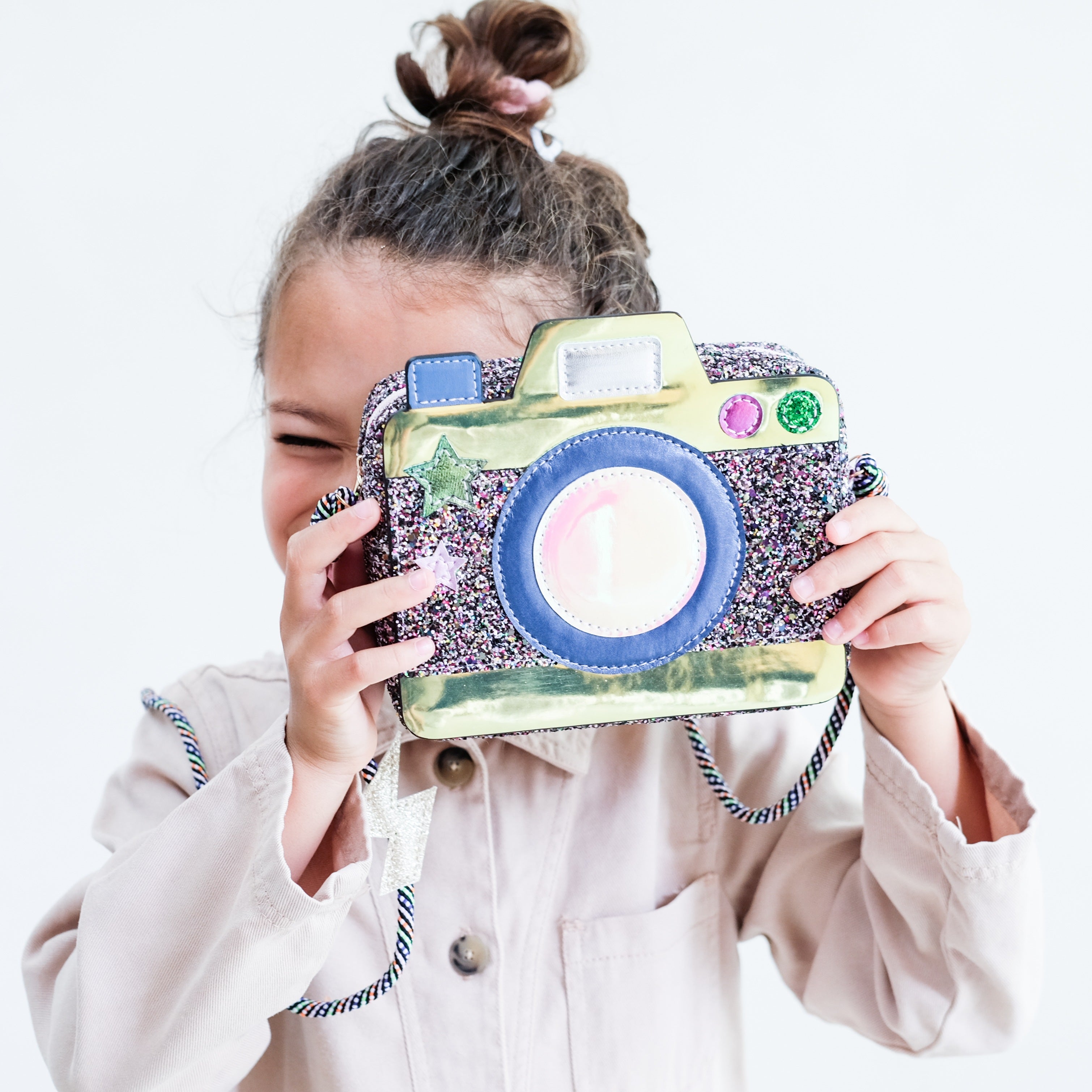 girl holding camera purse up to her eye
