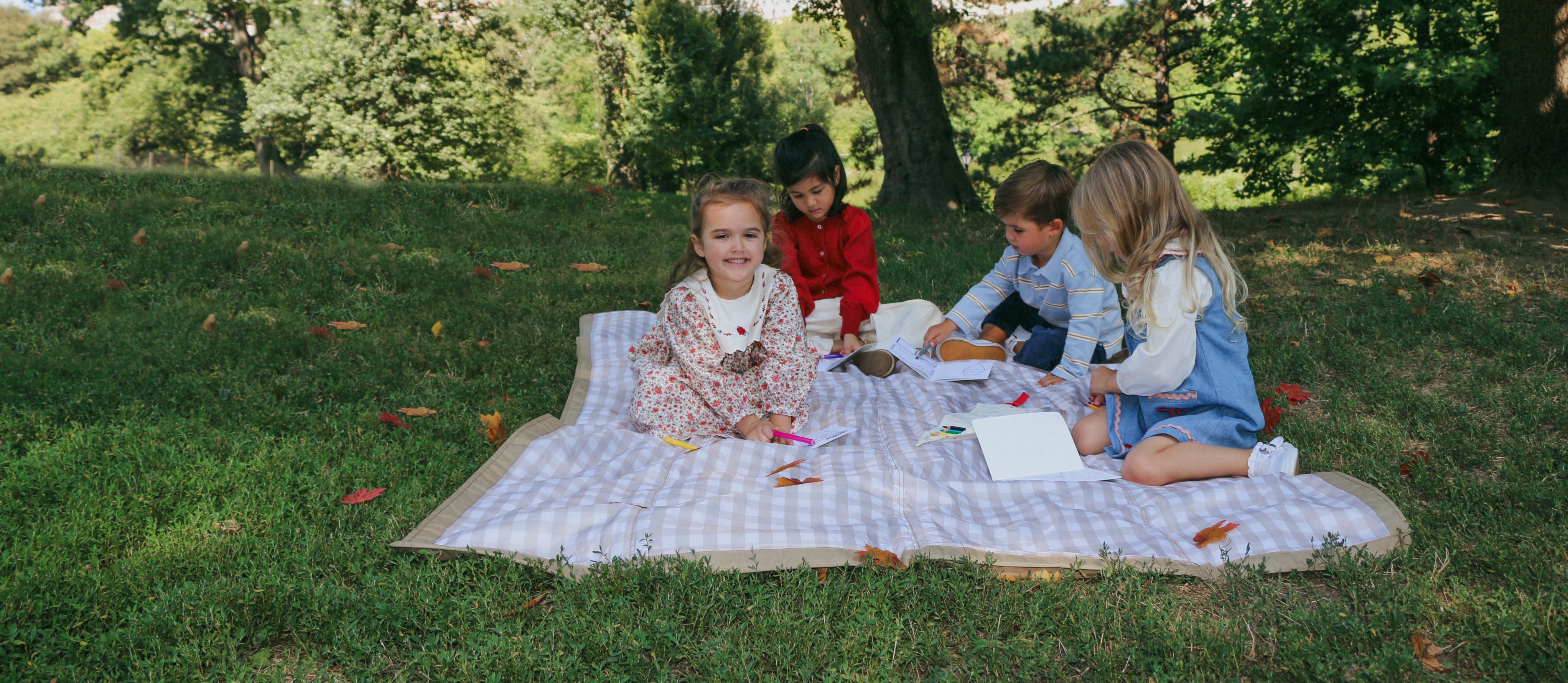 kids having a picnic in central park with coloring books