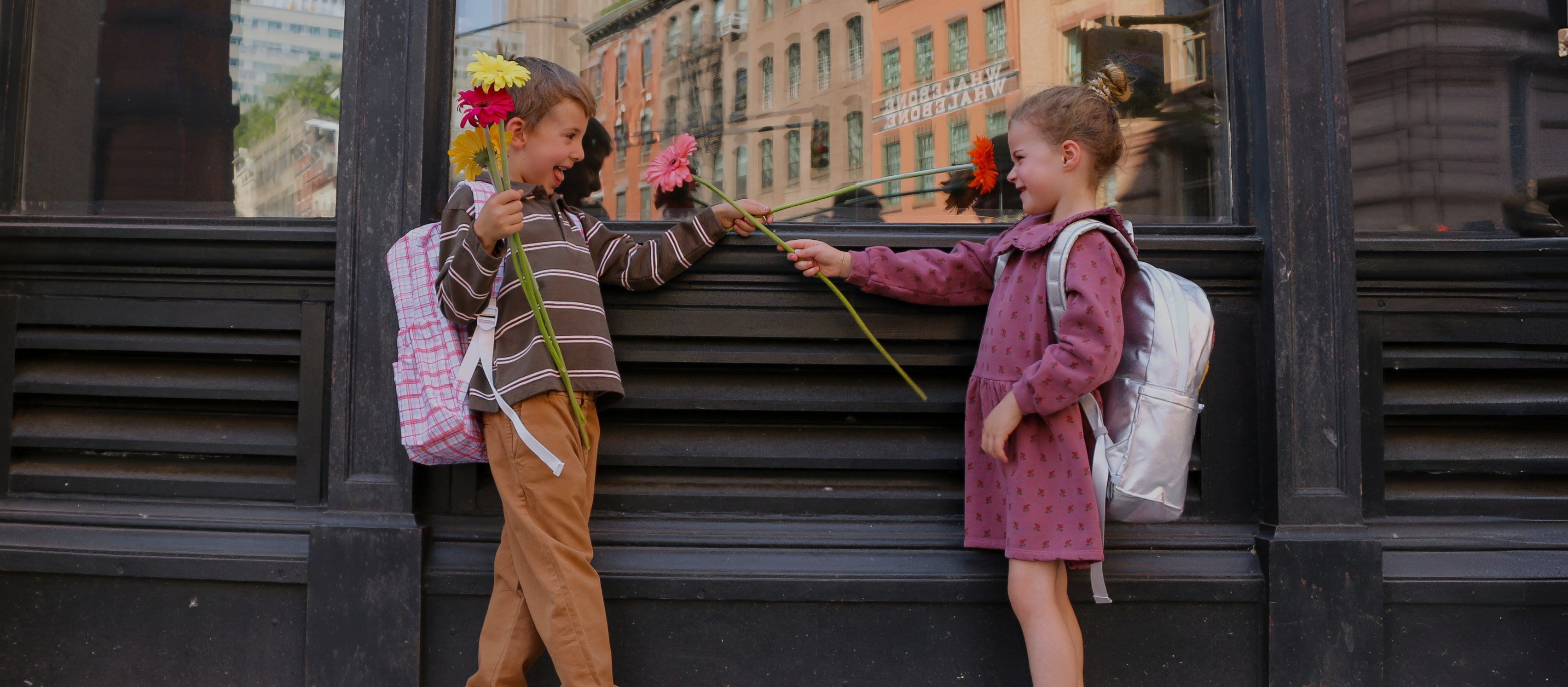 boy and girl wearing backpacks in nyc fall street