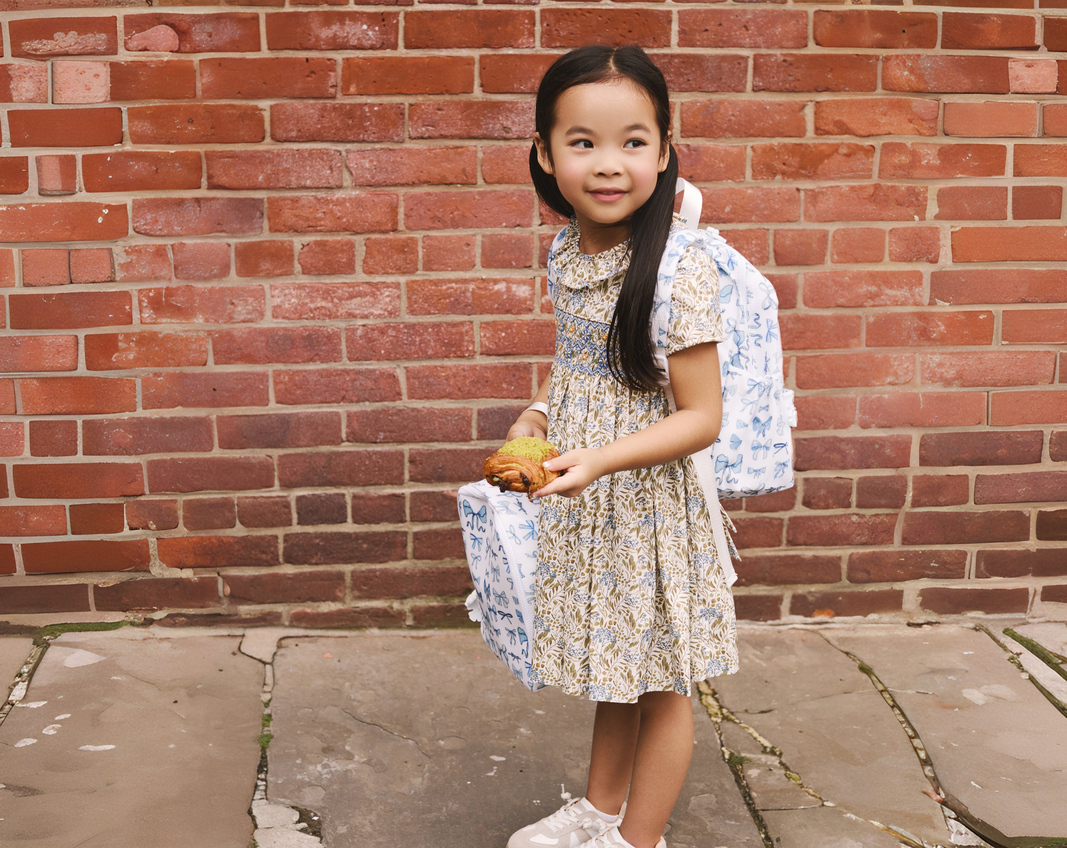 little girl with TRVL bow collection