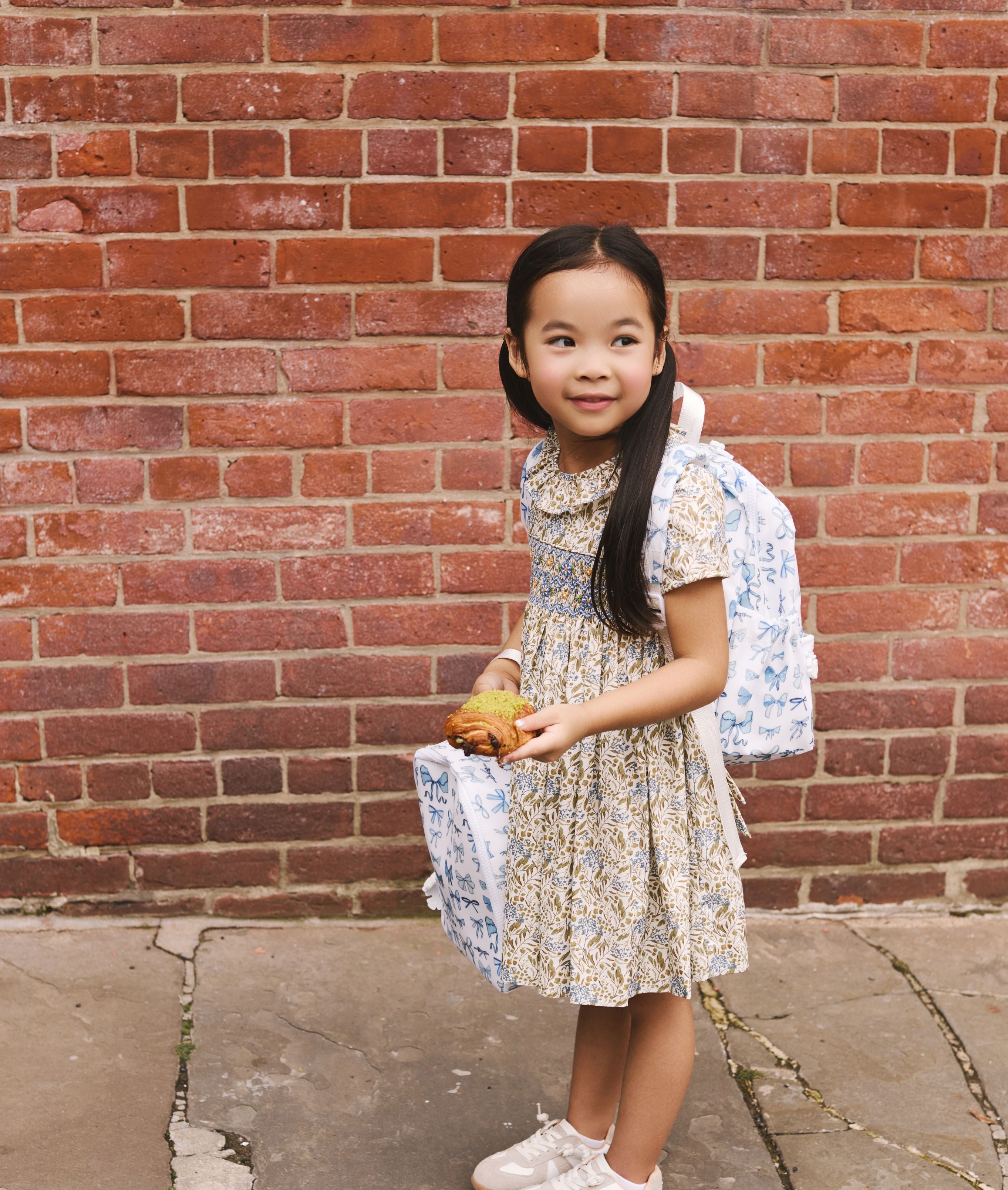 little girl with TRVL bow collection