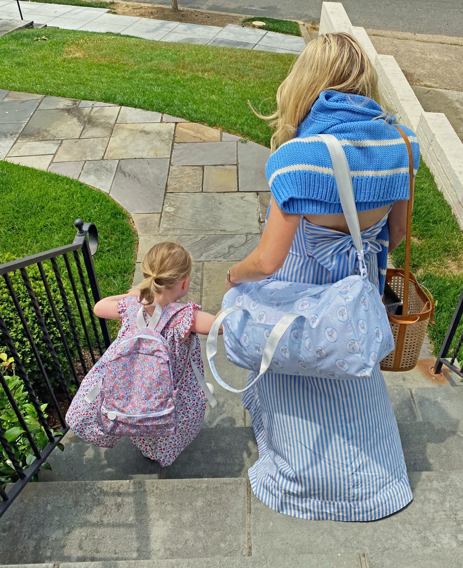 mom and young daughter holding hands
