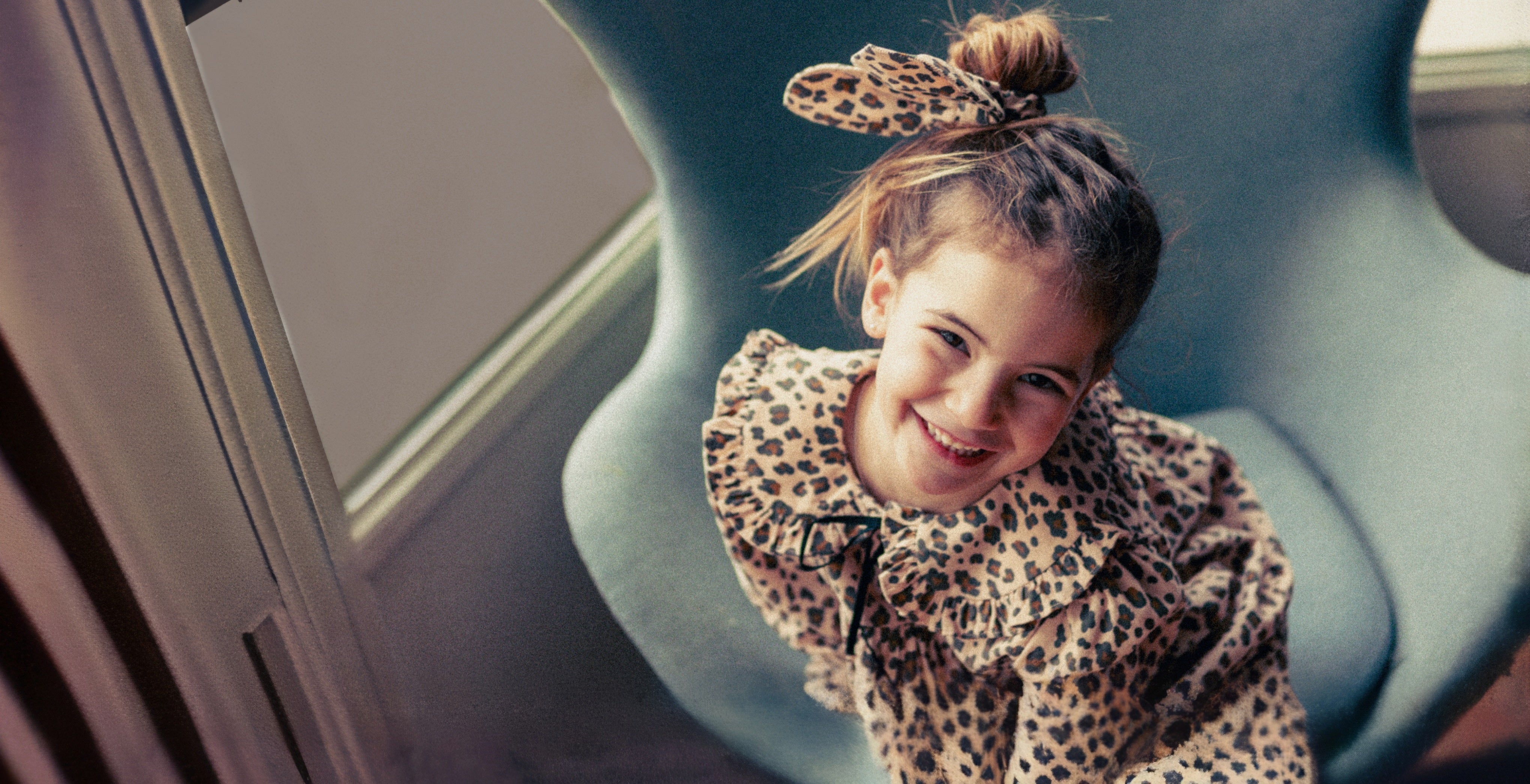 young girl wearing leopard print corduroy dres
