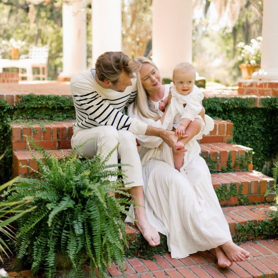 mom and dad holding baby