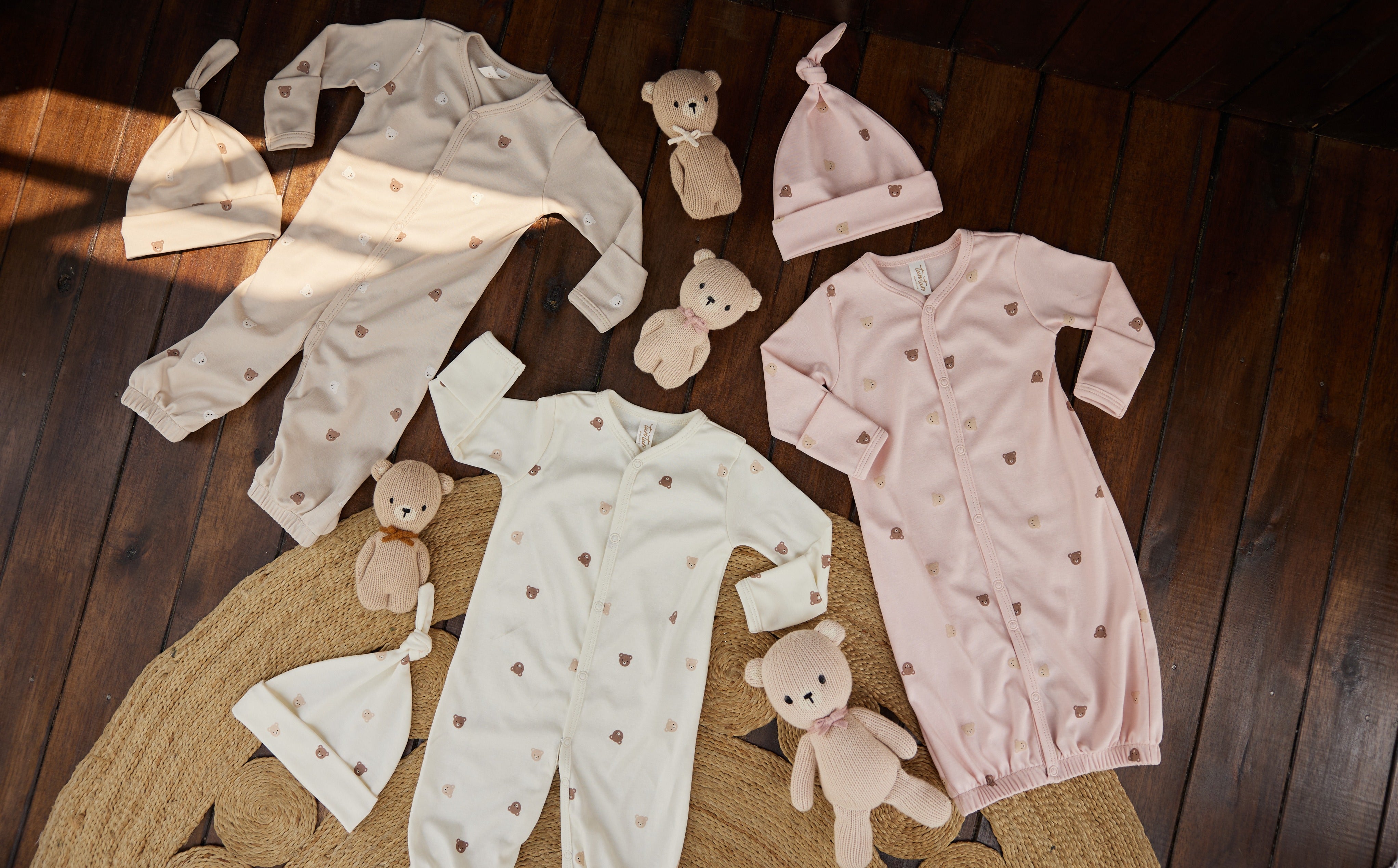 tun tun flatlay with 3 onesies styled