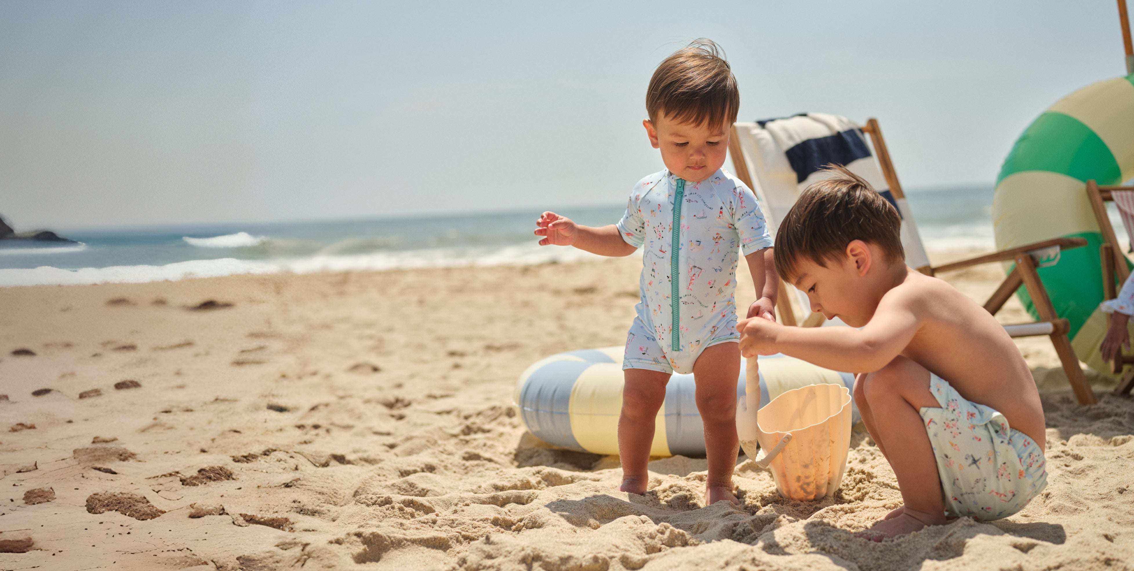 two boys playing on the beach