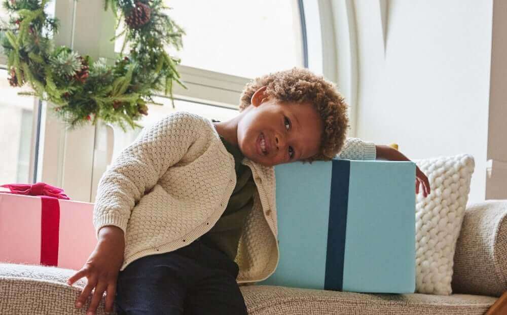 boy leaning on gifts