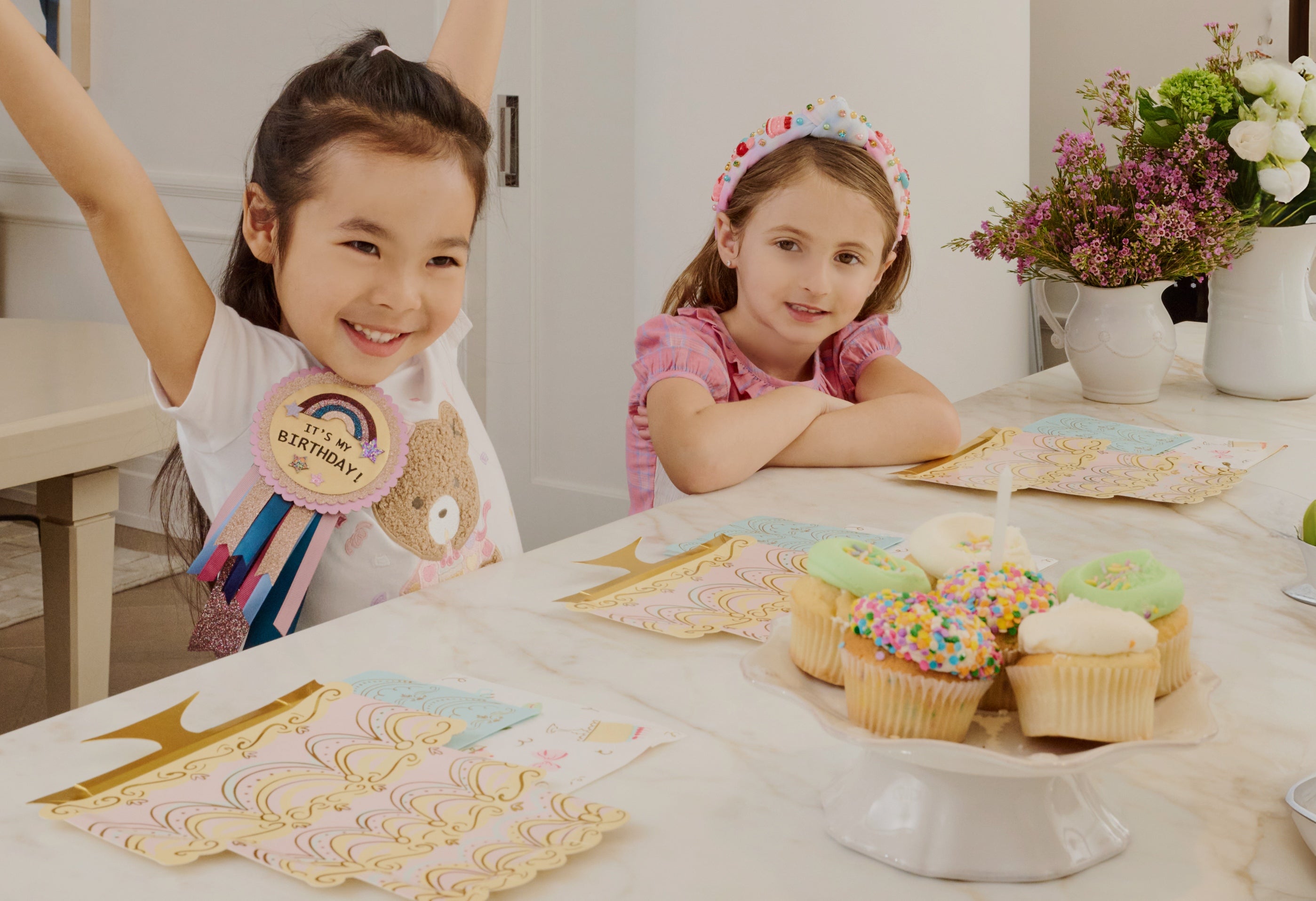 girl celebrating birthday with cupcakes
