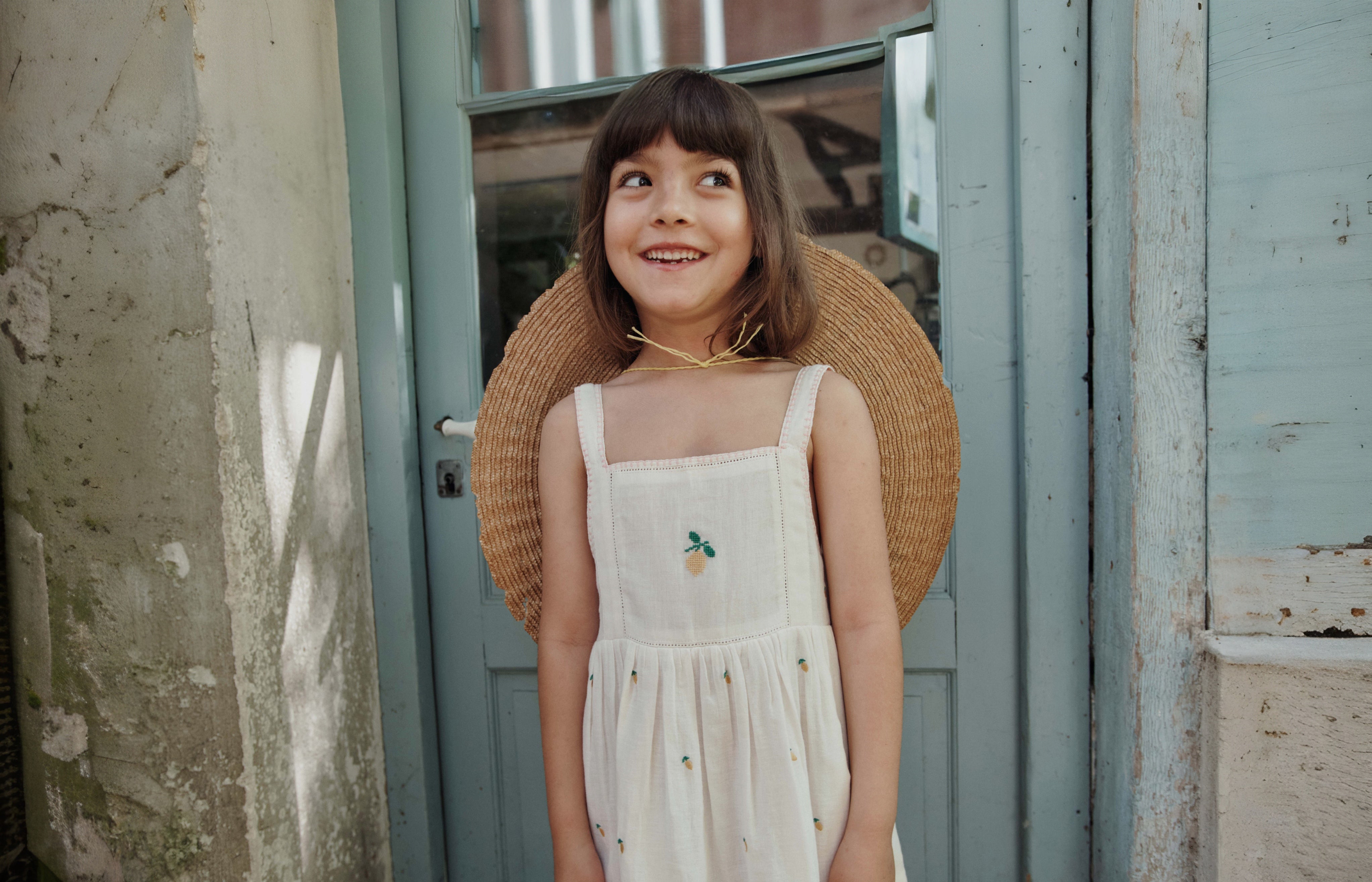 girl wearing embroidered lemon dress