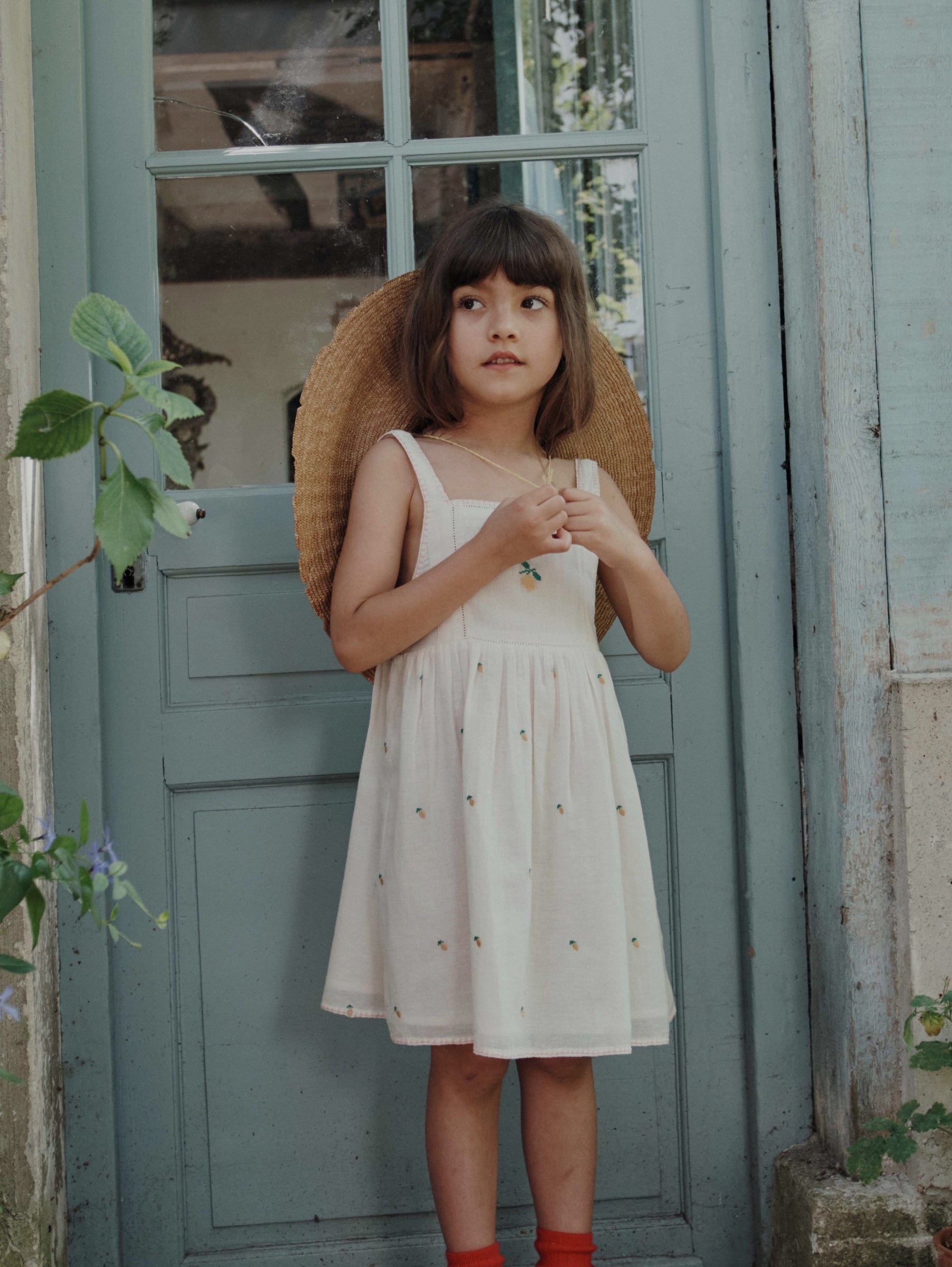 girl wearing embroidered lemon dress