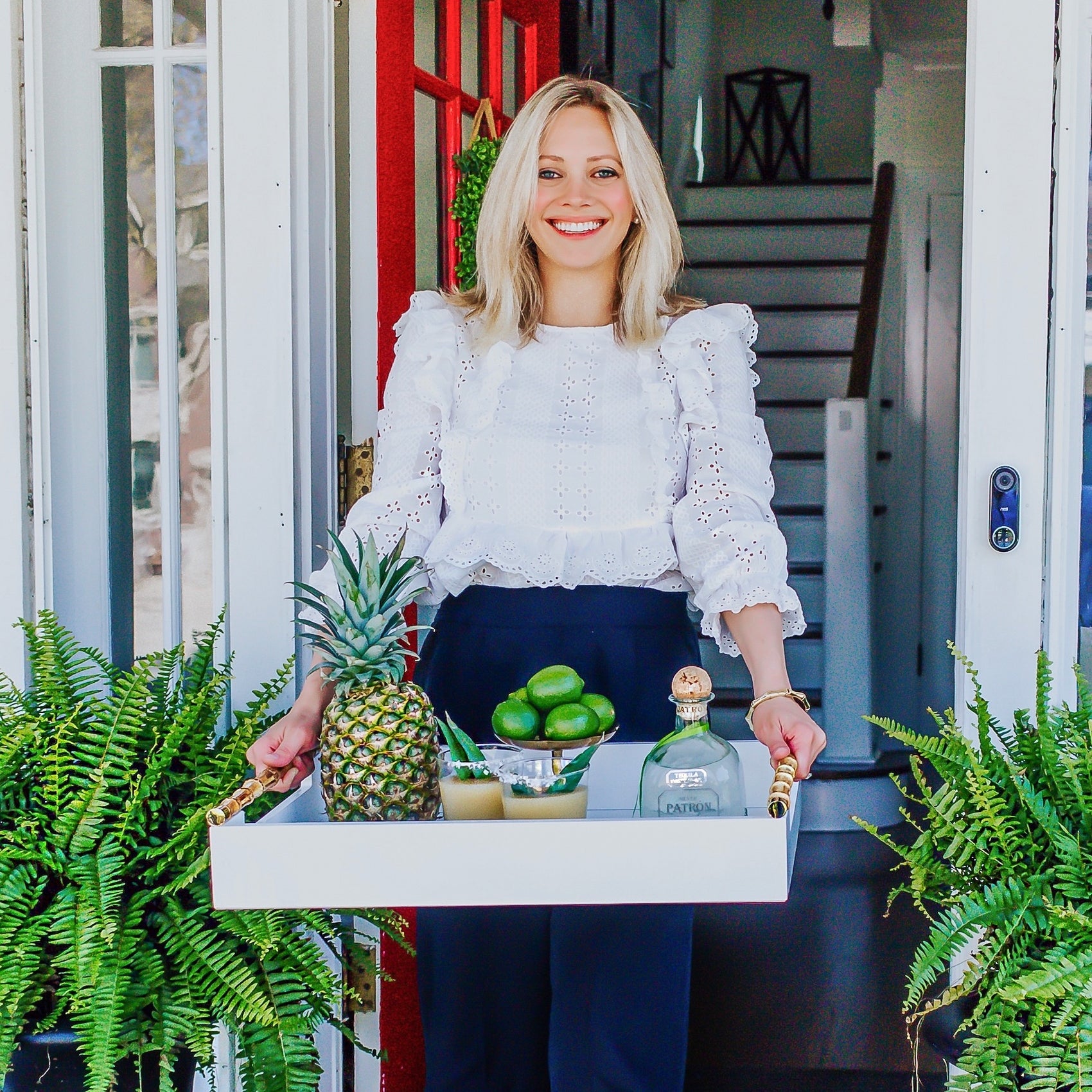 blonde woman holding tray of margaritas