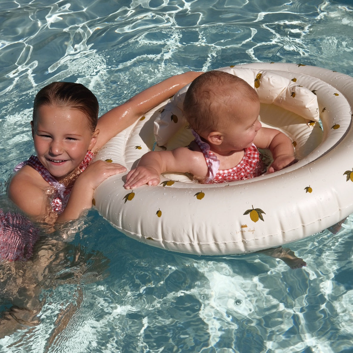 two young girls swimming in pool