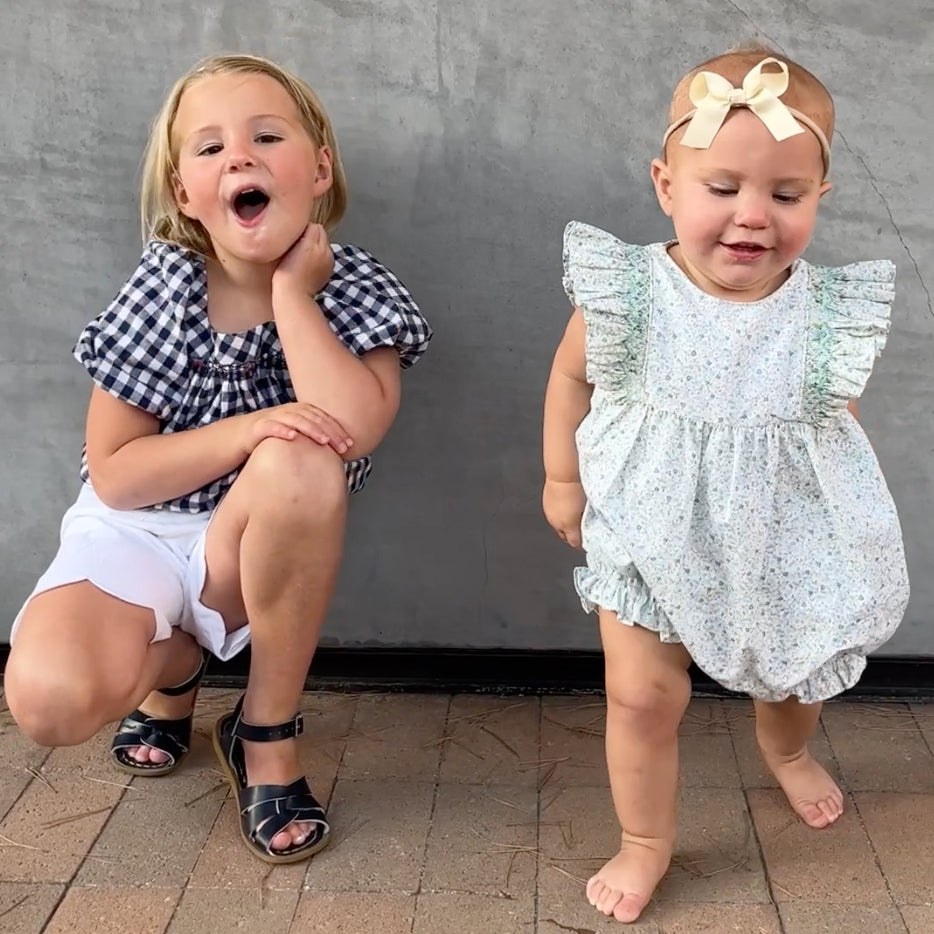two girls posing in outfits