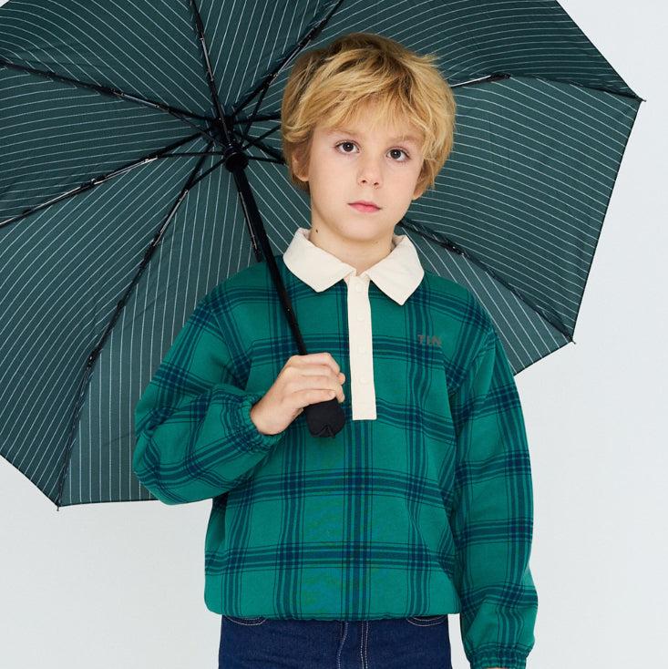 young boy wearing a blue and green plaid polo