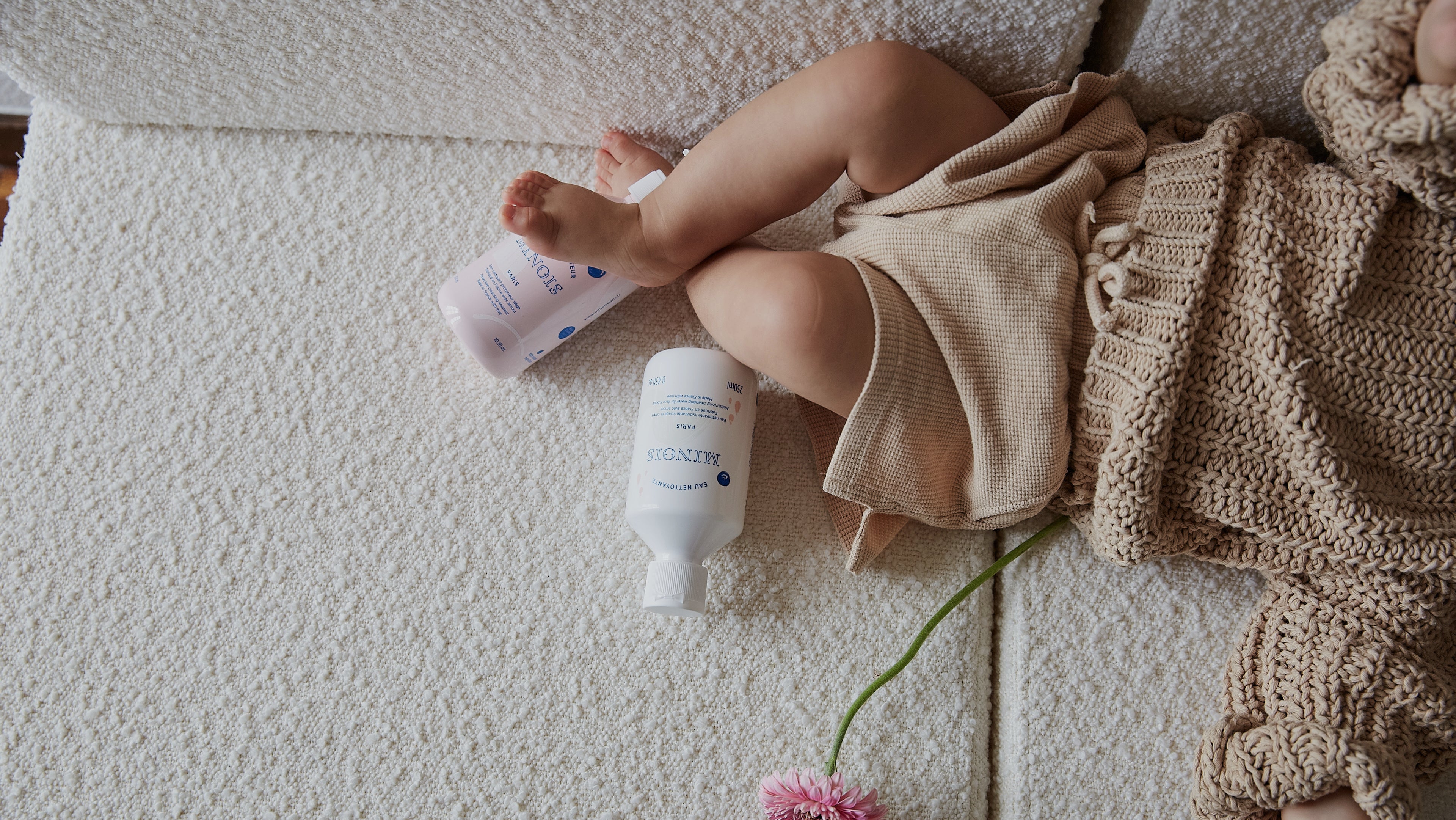 baby posing with bath products