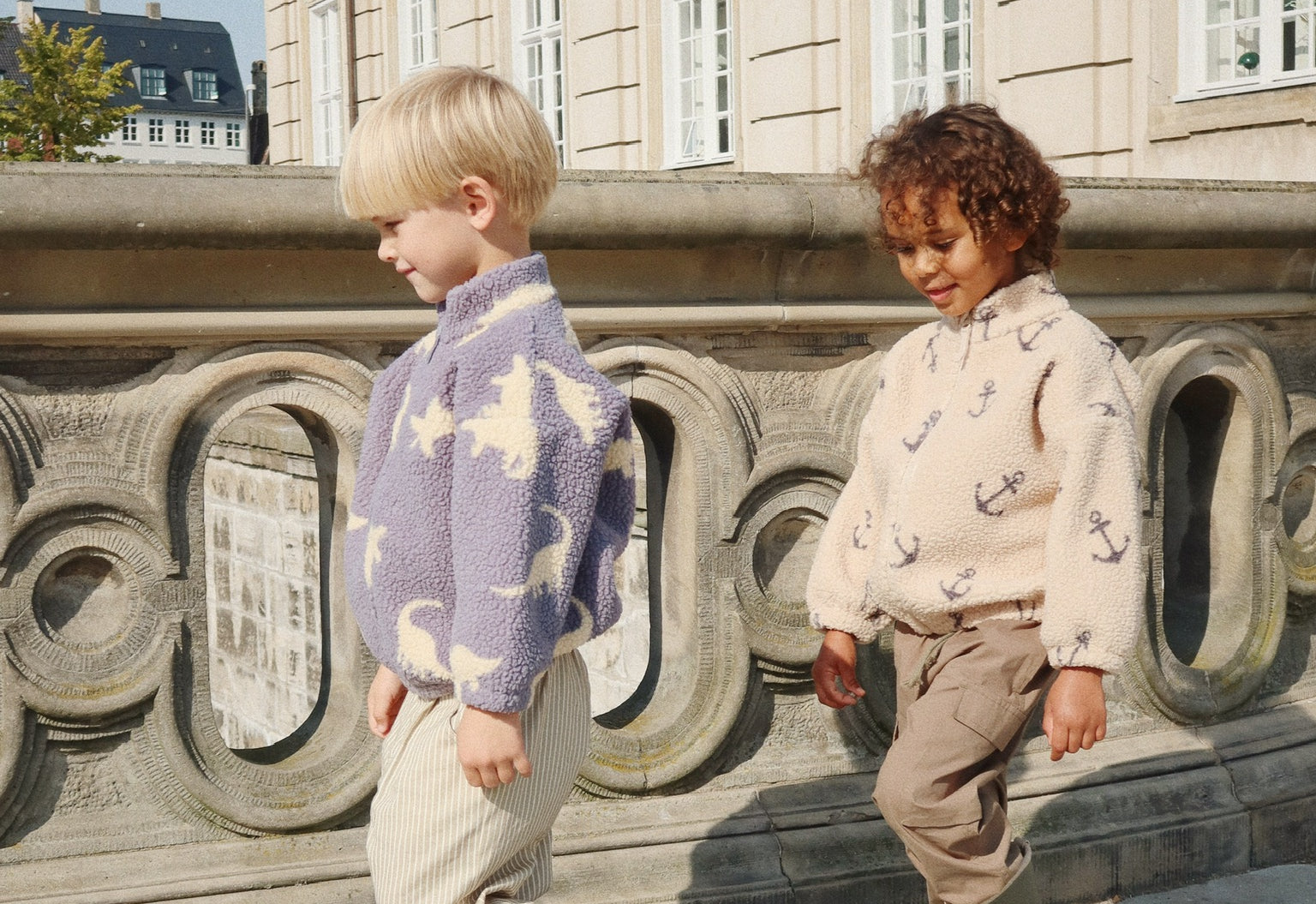 two young boys wearing konges fleece jackets walking